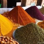 이라크 전통 향신료 종류 - **Prompt 1: A Vibrant Iraqi Spice Market**
    "A bustling, vibrant market stall in Baghdad, overflo...